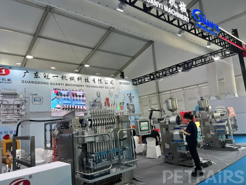 A panoramic view of Petfair Asia 2025 at the Shanghai New International Expo Centre, featuring crowded exhibition halls, international pet brands, and professional visitors.