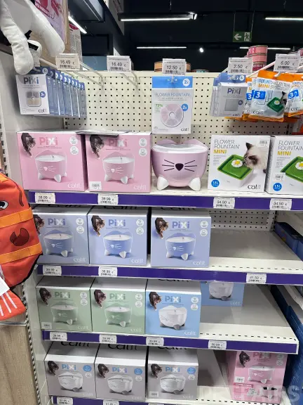 Interior view of Animalis pet store in France, showcasing neatly arranged pet food aisles, aquariums, and small animal enclosures — a modern retail space dedicated to pet care and professional service.