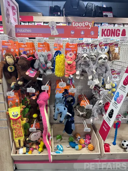 Interior view of Animalis pet store in France, showcasing neatly arranged pet food aisles, aquariums, and small animal enclosures — a modern retail space dedicated to pet care and professional service.