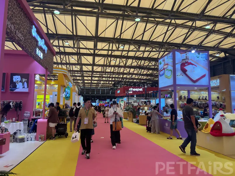 A panoramic view of Petfair Asia 2025 at the Shanghai New International Expo Centre, featuring crowded exhibition halls, international pet brands, and professional visitors.