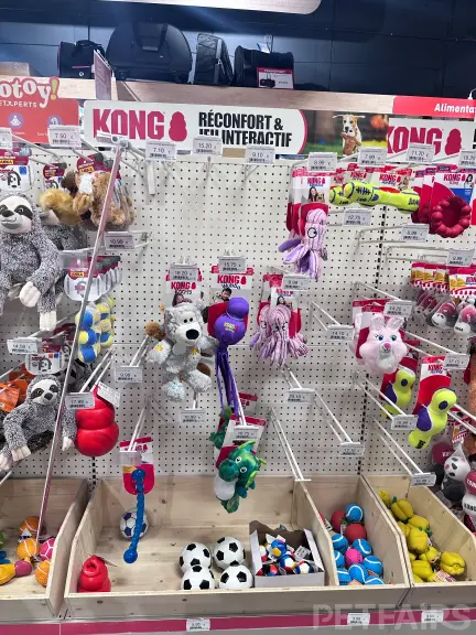 Interior view of Animalis pet store in France, showcasing neatly arranged pet food aisles, aquariums, and small animal enclosures — a modern retail space dedicated to pet care and professional service.