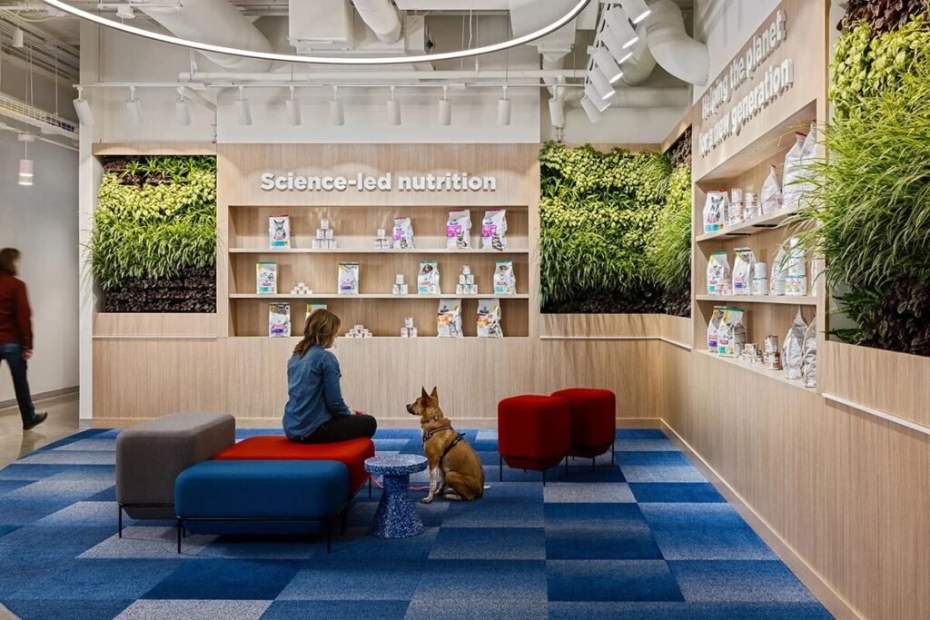 Hill’s Pet Nutrition office collaboration zone with colorful seating, eco-friendly materials, and pet-friendly features supporting employee wellness.