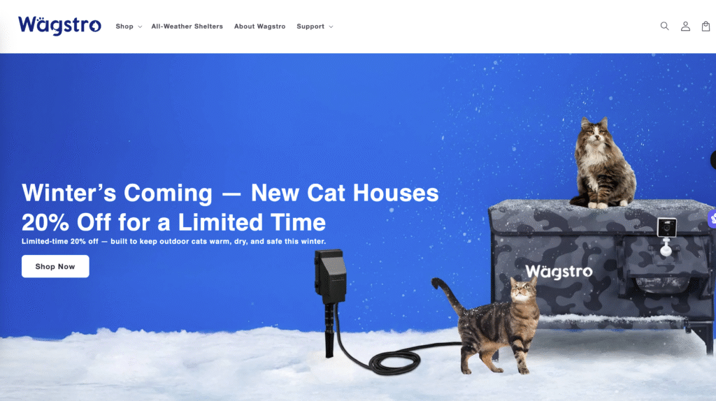 Heated outdoor cat house with raised base to prevent moisture and snow accumulation